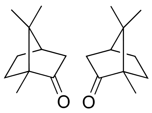 White camphor tablet burning with clean blue flame in brass camphor lamp during aarti ceremony