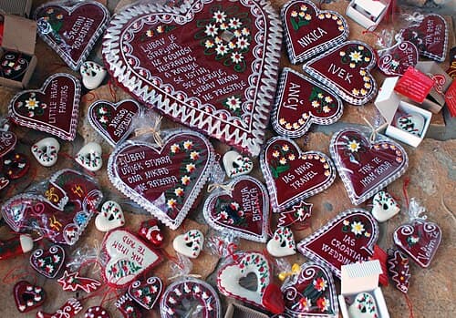Red Croatian licitar gingerbread heart decorated with white sugar icing and small mirror