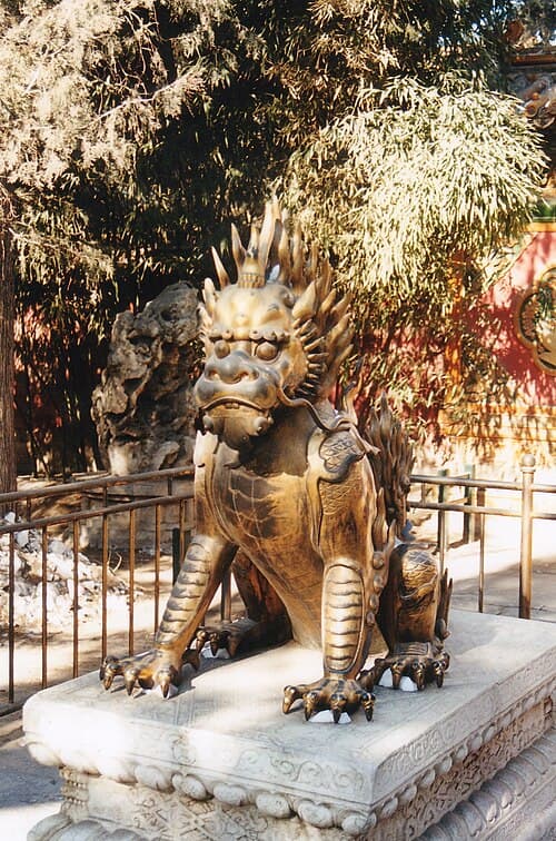 Stone Haetae guardian creature with scaled body, lion features, single horn, and protective expression at palace entrance