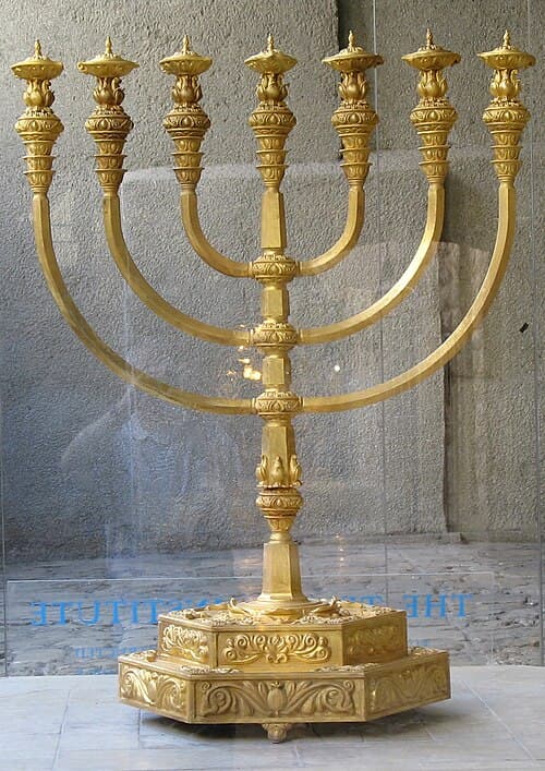 Gold seven-branched Temple menorah charm with decorative base and detailed craftsmanship