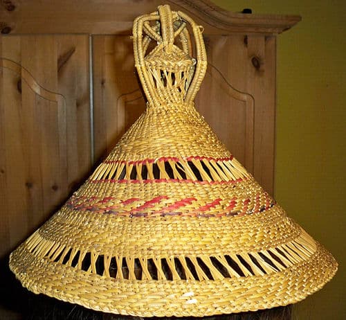 Traditional mokorotlo woven conical hat with topknot in natural grass colors, Lesotho national symbol